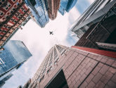 airplane above buildings jets flying high